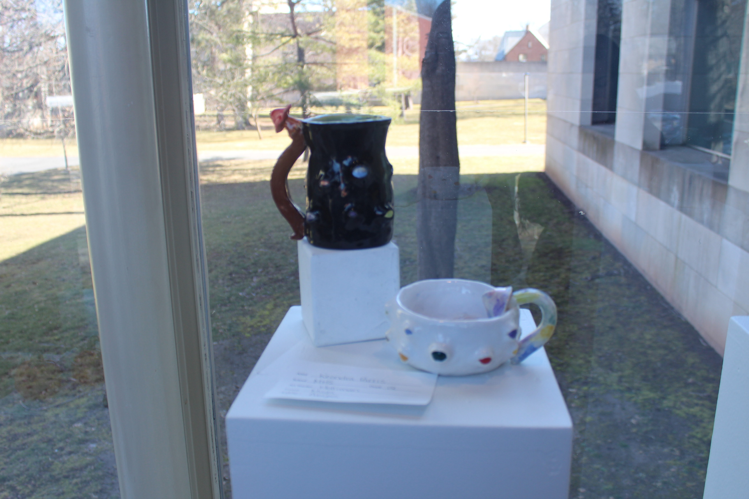 Student pottery on display in the gallery